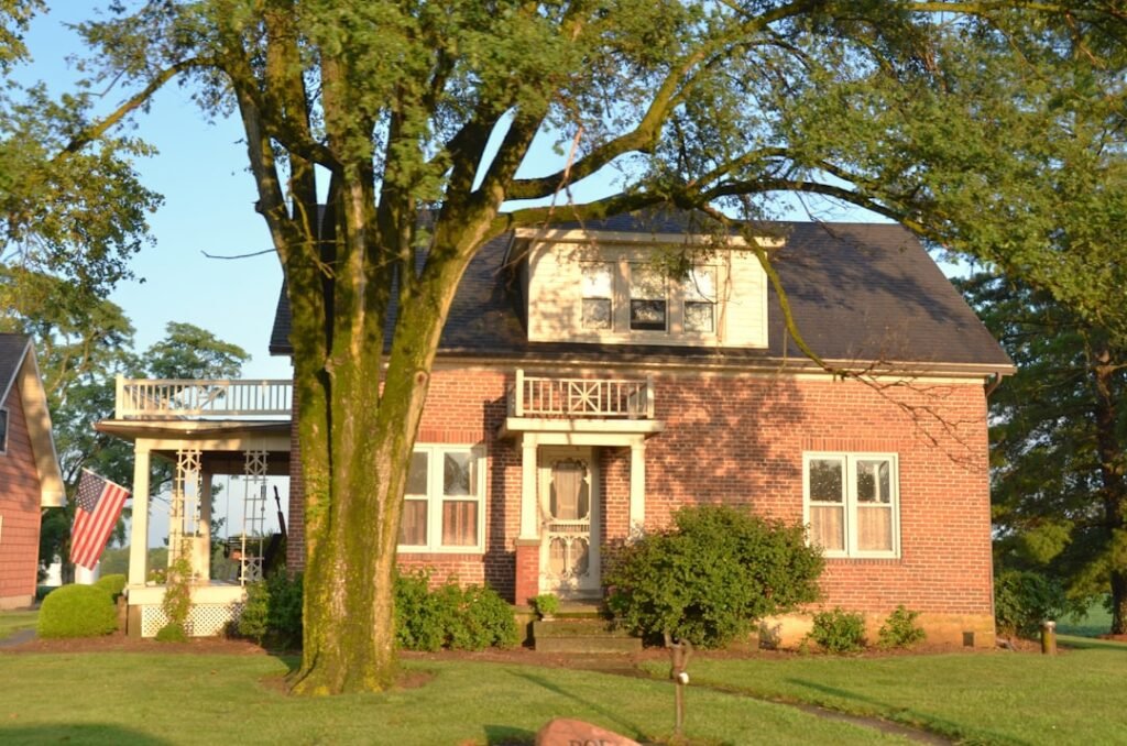 Illustrative brick home showing exterior walls, windows and a porch