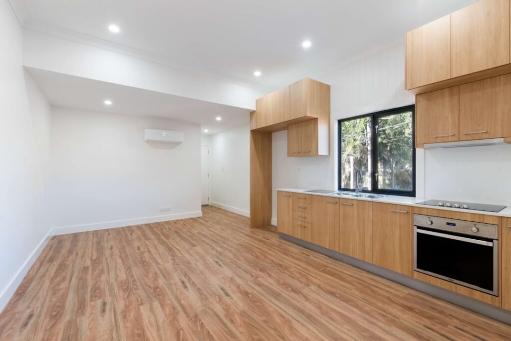 Illustrative finished living area and kitchen showing surfaces for photo documentation